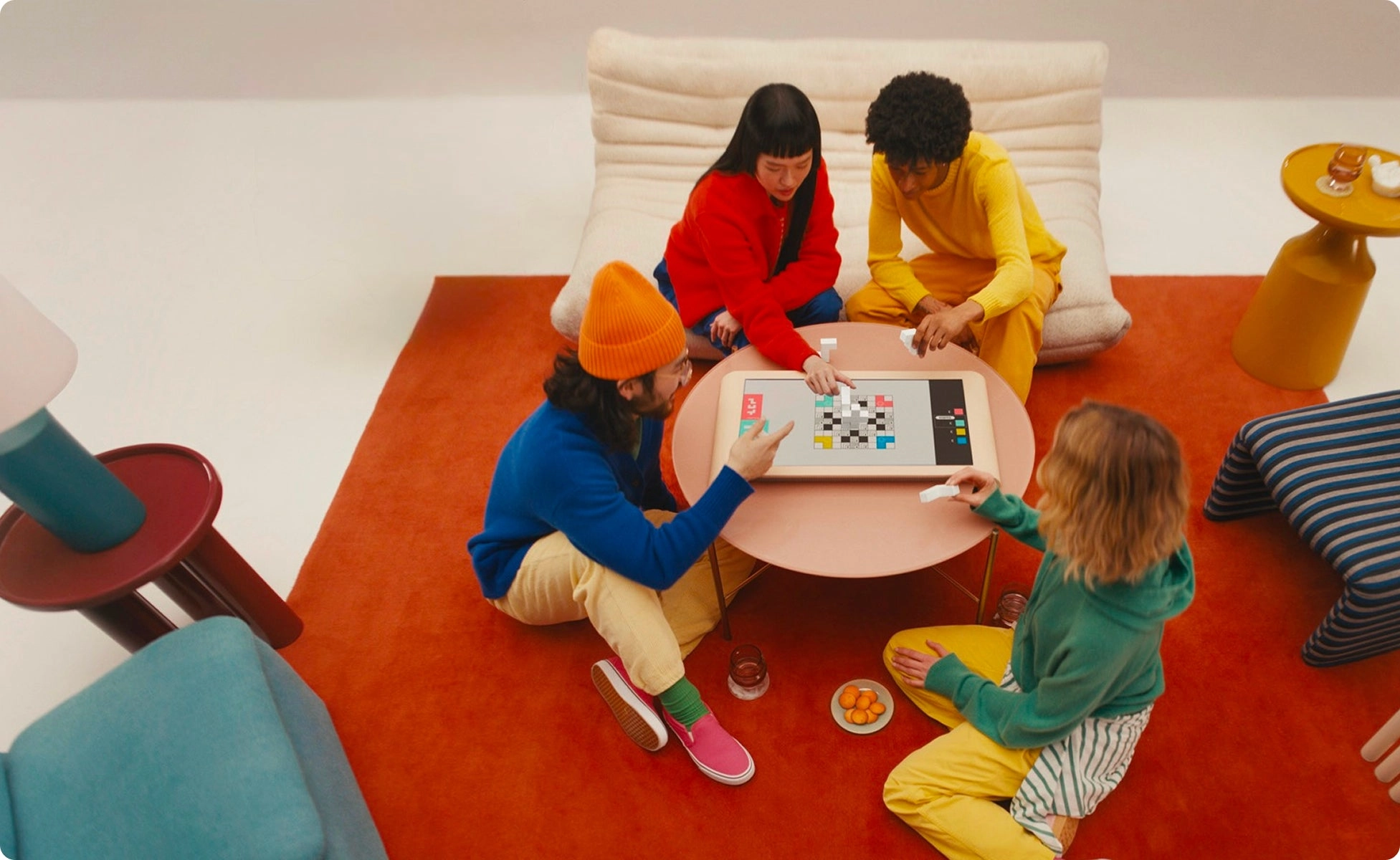 Overhead view of four friends playing a game on the Board tabletop console.